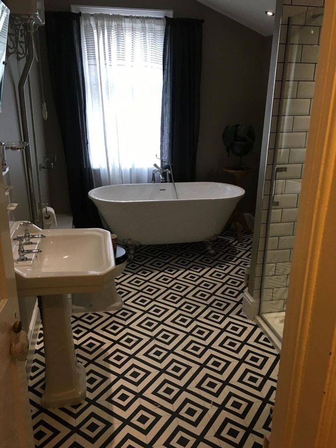 Bathroom with clawfoot bath and patterned floor