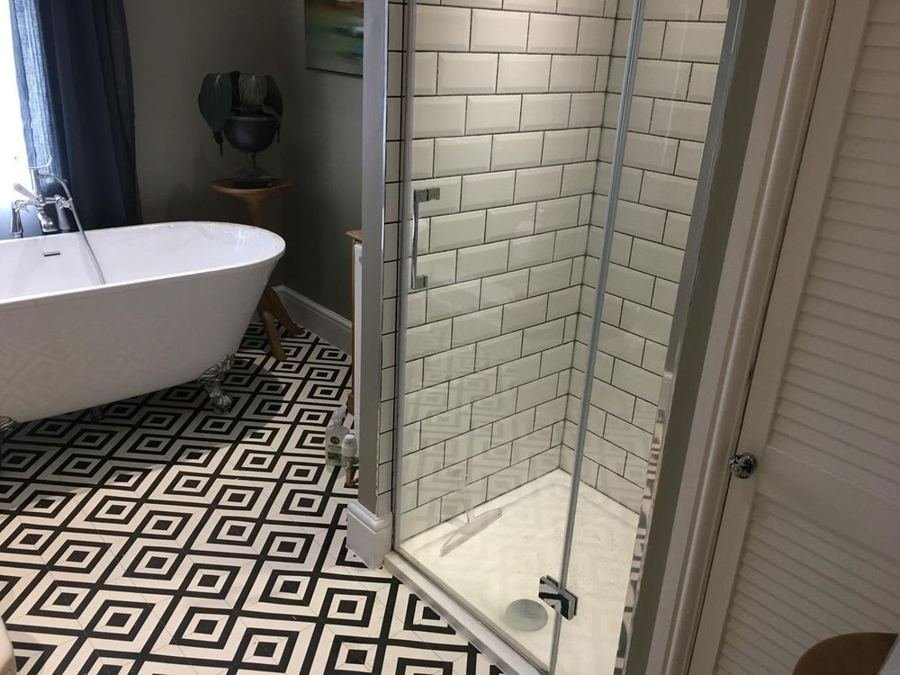 Rolltop bath and tiled shower enclosure