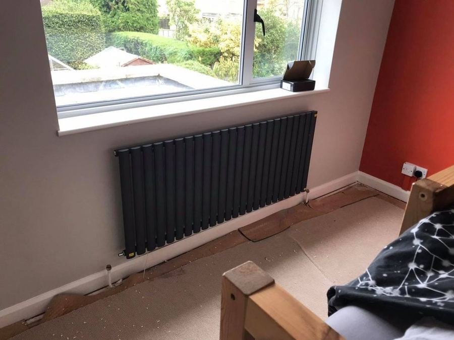 Anthracite designer radiator under a window